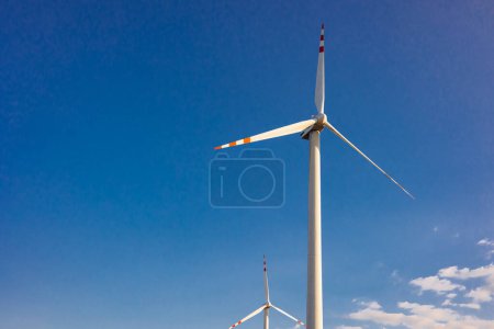 Photo for Windmill turbine with the blue sky on background - Royalty Free Image