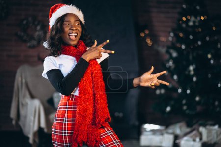 Photo for African american woman by the christmas tree - Royalty Free Image