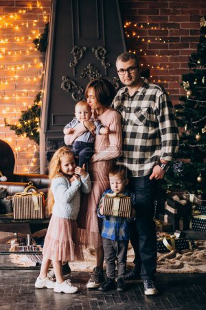 Photo for Big family on Christmas eve with presents by Christmas tree - Royalty Free Image