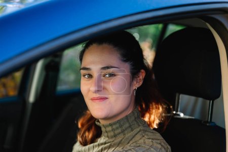 Photo for Beautiful 30 year old woman happy looking at camera from inside her car. Concept of lifestyle - Royalty Free Image