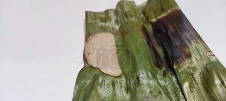 Photo for Close up on isolated white Otak-otak is a Southeast Asian fish cake made of ground fish meat mixed with spices and wrapped into leaf parcels.Otak-otak is traditionally served fresh,encased within the leaf parcel it is cooked - Royalty Free Image