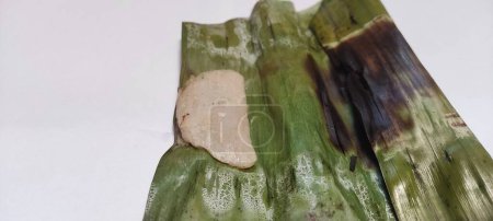 Photo for Close up on isolated white Otak-otak is a Southeast Asian fish cake made of ground fish meat mixed with spices and wrapped into leaf parcels.Otak-otak is traditionally served fresh,encased within the leaf parcel it is cooked - Royalty Free Image
