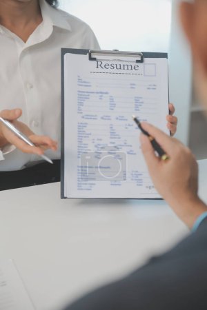 Close up view of job interview in office, focus on resume writing tips, employer reviewing good cv of prepared skilled applicant, recruiter considering application, hr manager making hiring decision