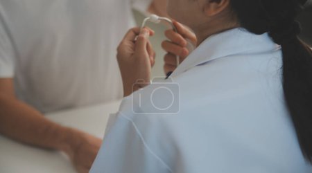 Foto de El médico joven está usando un estetoscopio para escuchar los latidos del corazón del paciente. Inyección de una doctora dándole un chequeo a un paciente masculino - Imagen libre de derechos