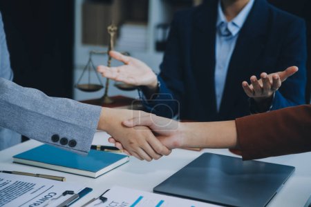 Photo for Businessman shaking hands to seal a deal with his partner lawyers or attorneys discussing a contract agreement. - Royalty Free Image
