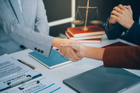 Photo for Businessman shaking hands to seal a deal with his partner lawyers or attorneys discussing a contract agreement. - Royalty Free Image
