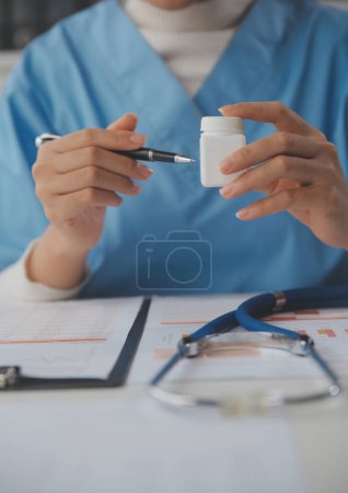 Photo for Doctor writing out RX prescription selective focus - Royalty Free Image