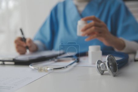 Photo for Doctor writing out RX prescription selective focus - Royalty Free Image
