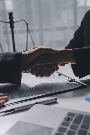 Photo for Businessman shaking hands to seal a deal with his partner lawyers or attorneys discussing a contract agreement - Royalty Free Image