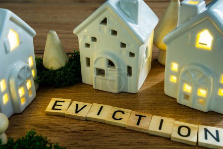 eviction in wooden letters crossword puzzle ceramic house with lights on
