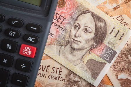 Taschenrechner auf dem Haufen der tschechischen Kronenbanknoten, der ein Inflationskonzept symbolisiert