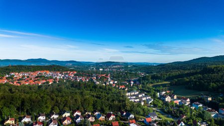 The aerial view showcases the town of Walbrzych nestled amidst lush green trees.