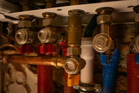 A close-up shot of a series of plumbing valves and pipes