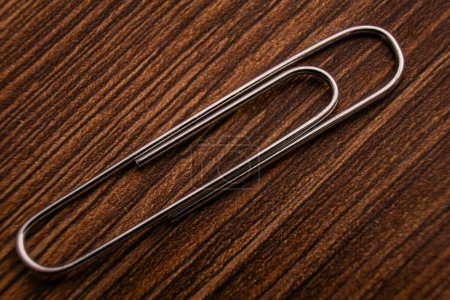 Silver Paperclip on Wooden Surface