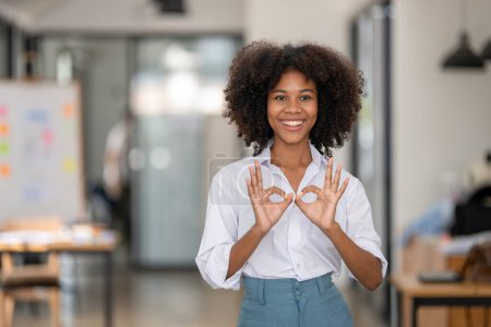 Téléchargez les photos : Portrait de jolie femme noire souriante montrant ok signe, gai attentif avec deux mains OK symbole - en image libre de droit