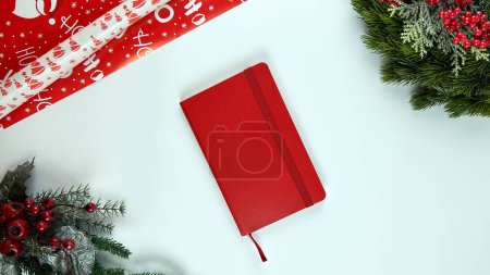 Photo for Juniper branches with New Year's decor. Christmas, new year background. Coniferous juniper branches, red notebook. Top view, flat design. - Royalty Free Image