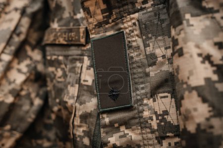 Photo for An element of the Ukrainian military uniform with chevrons and the shoulder strap of a junior lieutenant. Close-up, warm colors. - Royalty Free Image