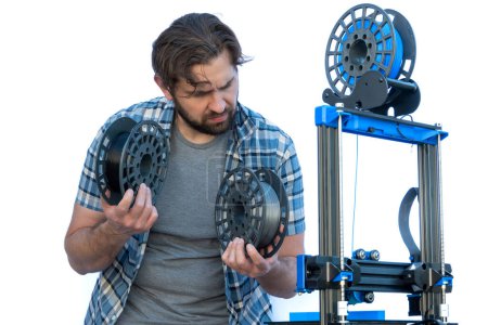 Photo for Man selecting filaments to make a 3D print. - Royalty Free Image