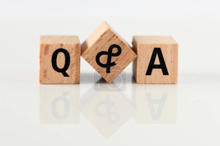 Photo for Q and A - short for question and answer. The word q & a arranged from wooden letters - Royalty Free Image