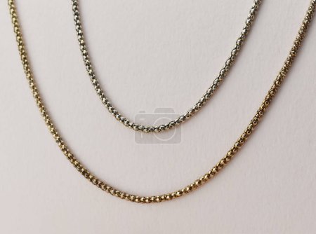 Gold chain on a white background. Jewelry background. Copy space.