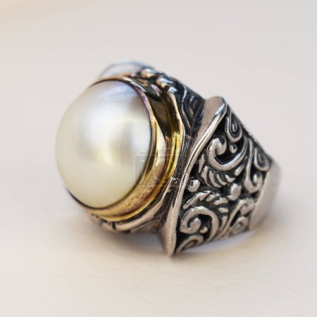 Jewelry ring with pearl on a white background. Close up.