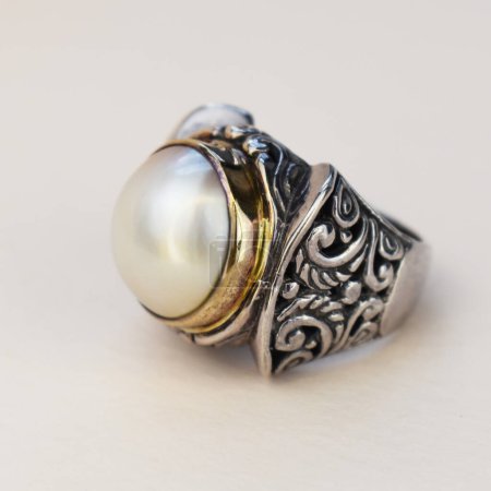 Jewelry ring with pearls on a white background close up