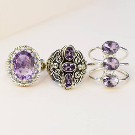 Jewelry ring with purple amethyst on a white background.
