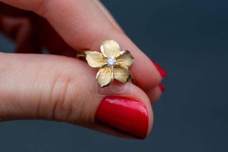 Wedding ring in the form of a flower in the hand