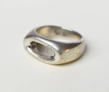 Close-up of silver ring on white background. Macro shot.