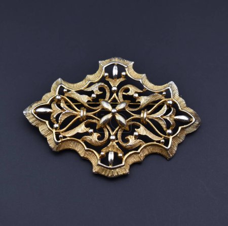 Vintage gold ornament on a black background. Flat lay, top view.