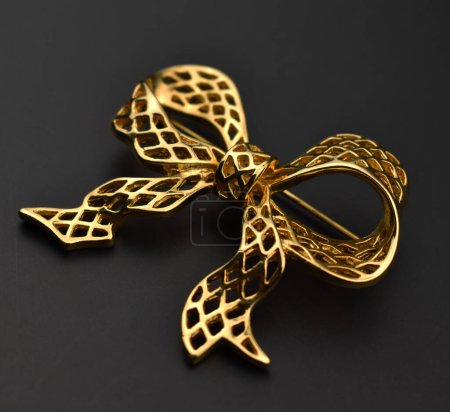Golden bow on a black background. Shallow depth of field.