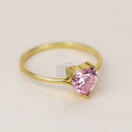 Jewelry ring with pink sapphire isolated on white background