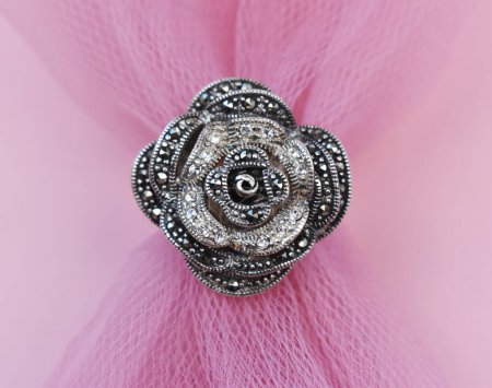 brooch on a pink background, close-up, selective focus