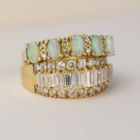 Jewelry diamond ring with green emerald on a white background