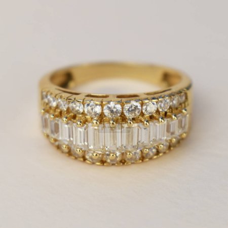 Close up gold diamond ring on white background. Luxury jewellery.