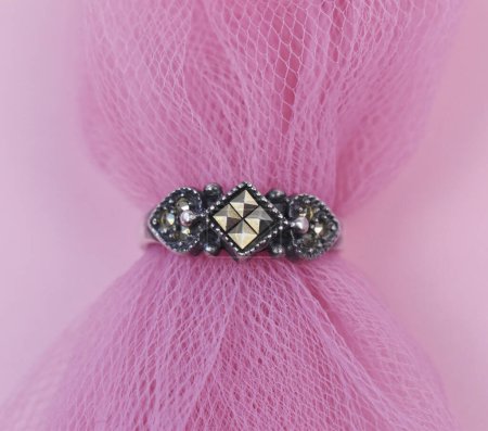 wedding ring with diamonds on a pink veil close-up