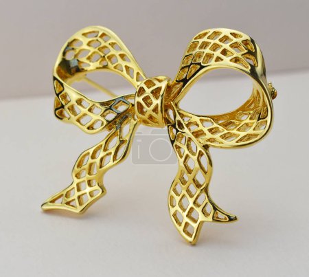Golden bow on a white background. Jewelry for the bride.