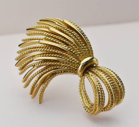 Gold hairpin on a white background, close-up, selective focus