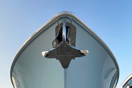 Anchor on cape of the ship close up, luxury yacht leisure motor boat with raised metal anchor 