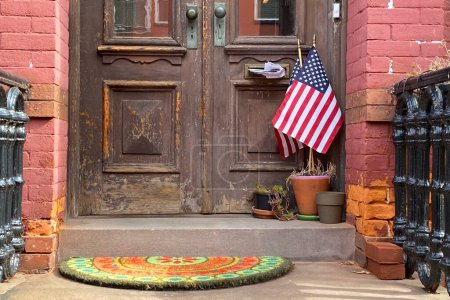American flag in front of a brown door in New York City.