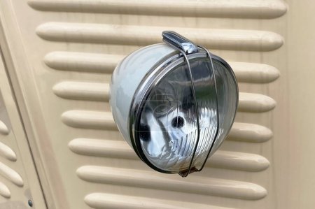 Detail of a vintage car headlight, closeup of photo