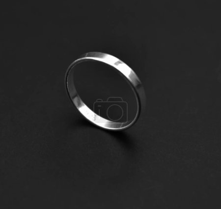 Wedding ring on a black background. Close-up.