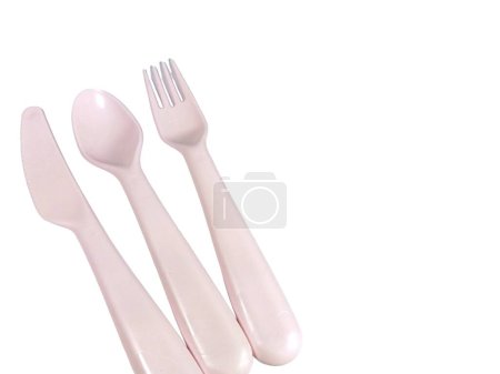 Pink plastic cutlery isolated on white background