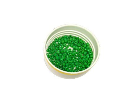 Small green beads on bowl, isolated on white background