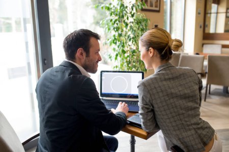Man is explaining something on computer to his partner