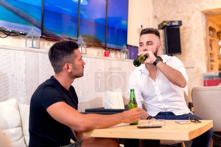 Friendly talk in bar and drinking beer