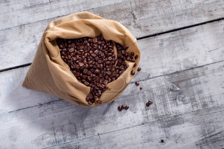 Coffee beans in sack on wooden