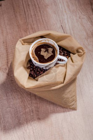 Fresh coffee in a sack with coffee beans on table