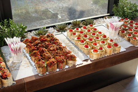 High angle view of snacks, arranged on table by window.