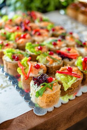Close - up of snacks, mini sandwiches with vegetables.